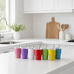 Babycino cup designed for small hands, featuring insulation and a stainless steel straw.