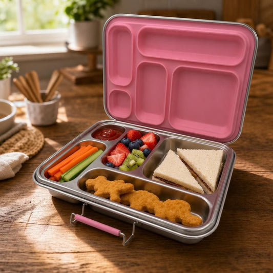 Stainless-steel large lunchbox with 5 compartments, filled with kid-friendly foods like sandwiches, fruits, and snacks, on a rustic kitchen counter.