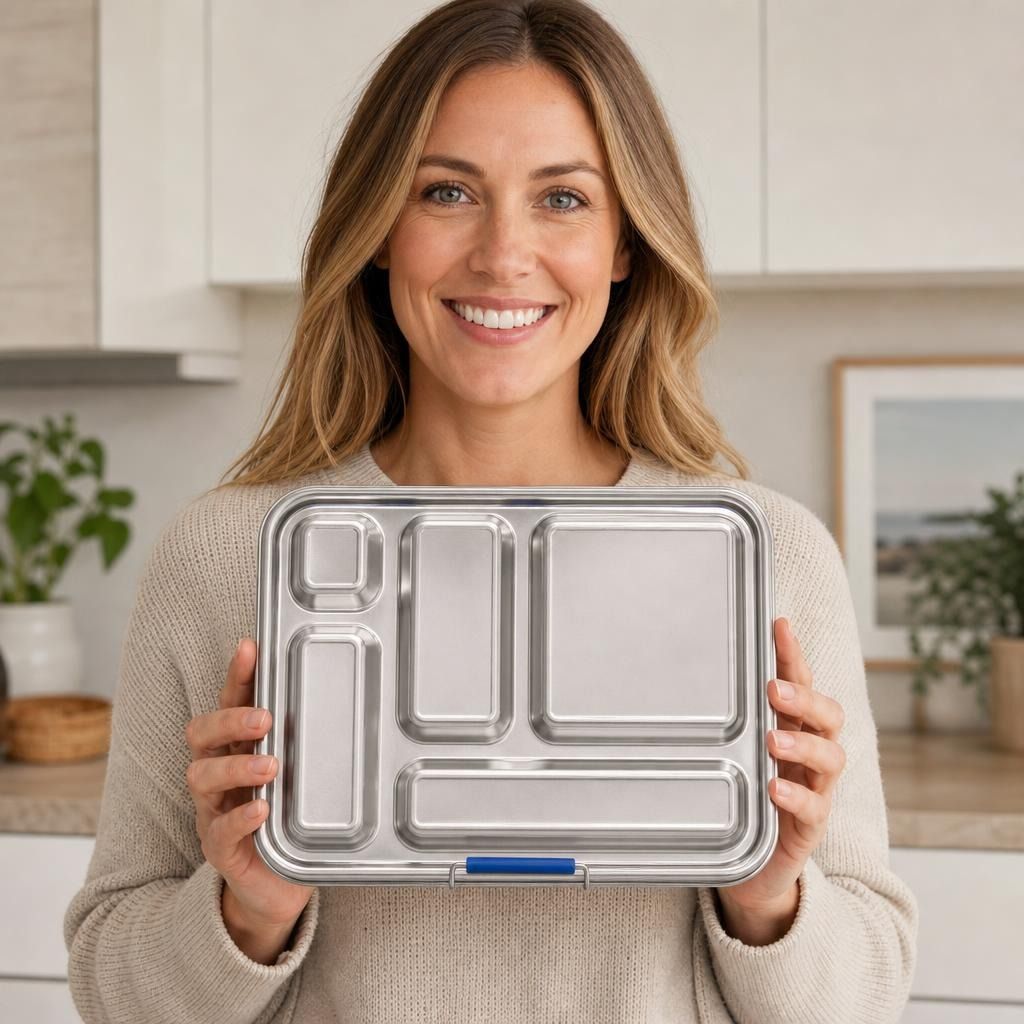 Front view of stainless-steel large lunchbox with five compartments held by a friendly person, showcasing its sleek design and custom engraving potential.