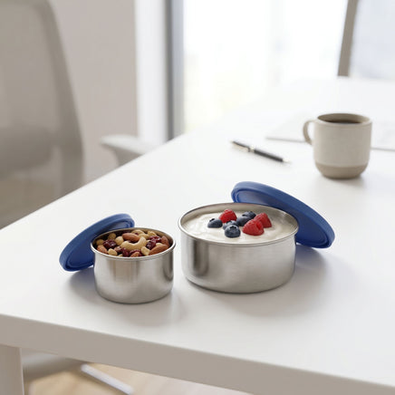 Two-pack snack pots with silicone lids, small with almonds and large with berry yogurt, set on a white background for office snack scene.